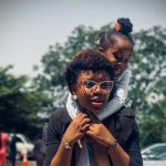 A lady carrying a child