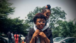 A lady carrying a child
