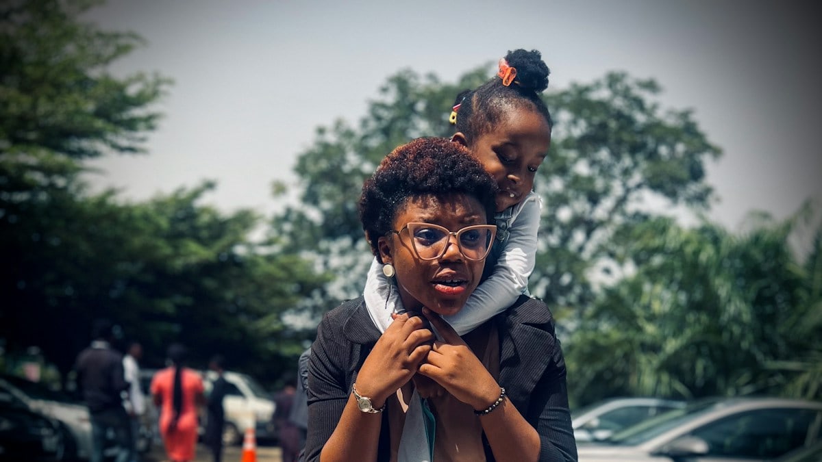 A lady carrying a child